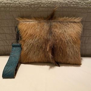 Merrick’s Custom Leather Cowhide hair on hide wristlet clutch.